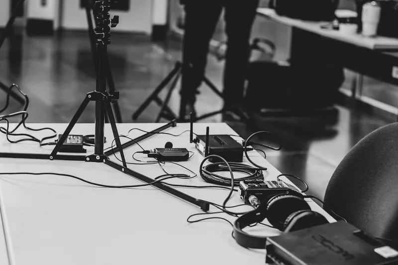 Microphone and headphones at a recording desk
